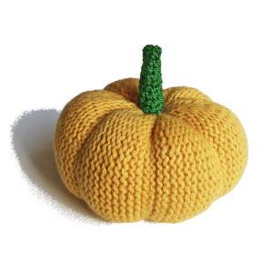 photo of a yellow knitted pumpkin for illustrating knitting tutorial for beginner knitters